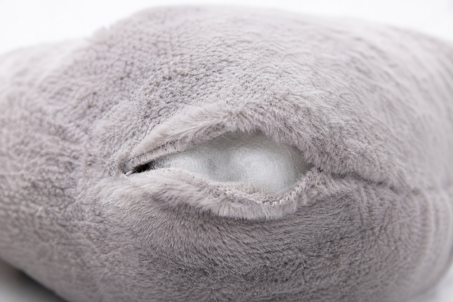 Open seam on a plush toy corner under bright inspection light
